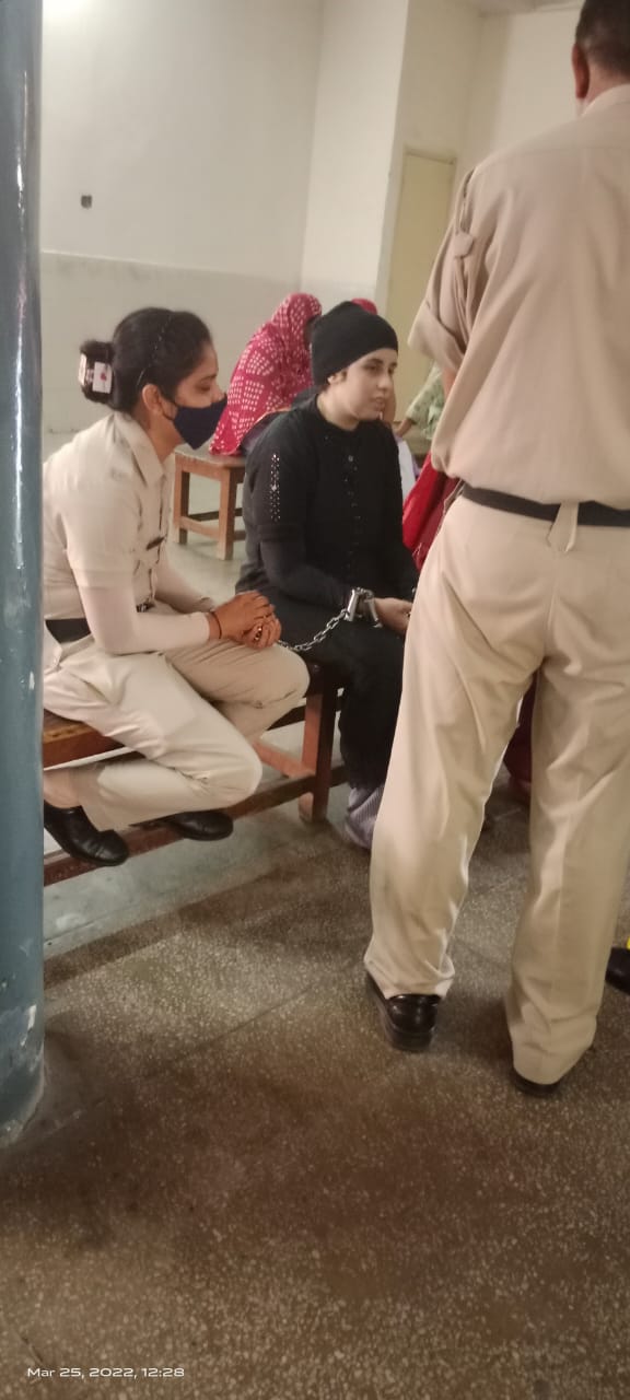 Legal support for a woman prisoner during a court hearing, March 2022
