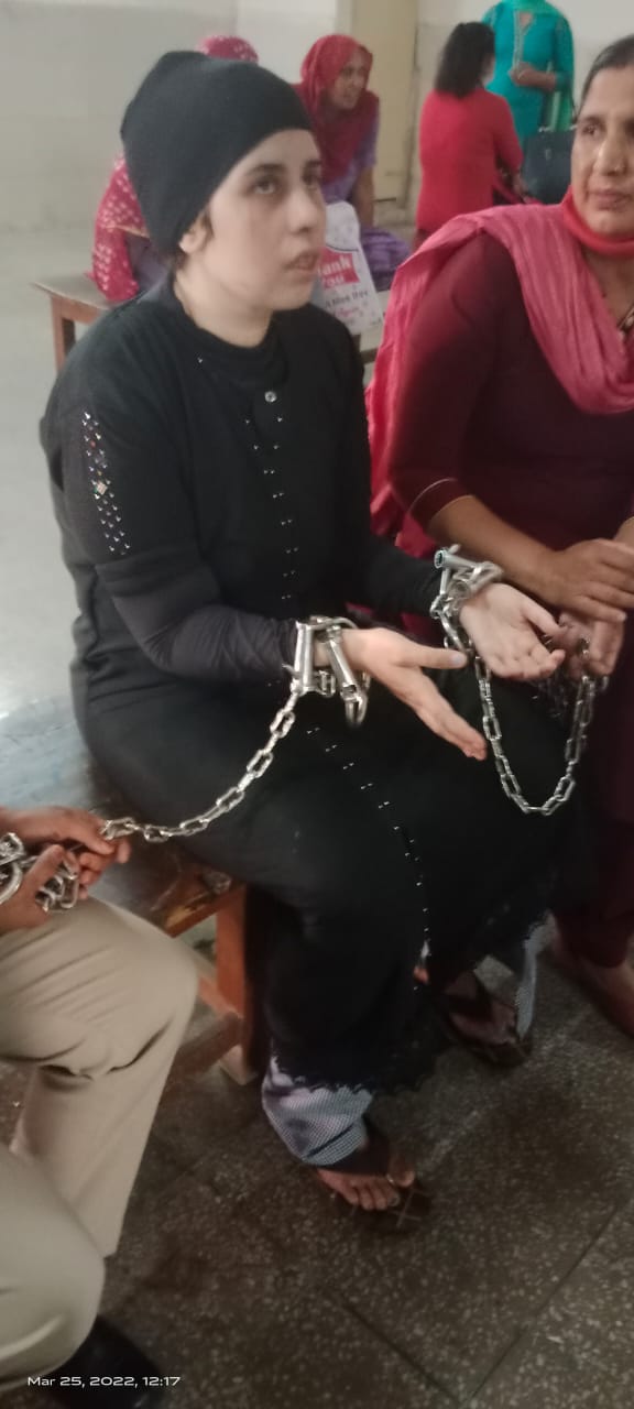 Legal support for a woman prisoner during a court hearing, March 2022