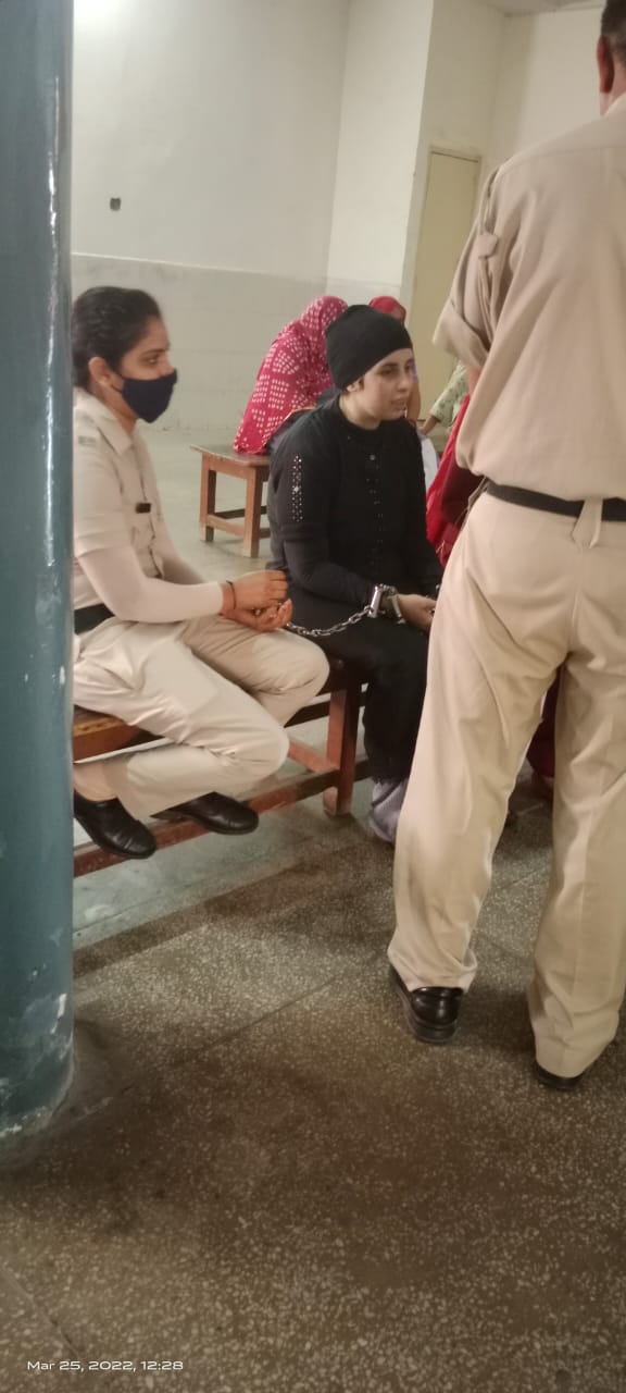 Legal support for a woman prisoner during a court hearing, March 2022