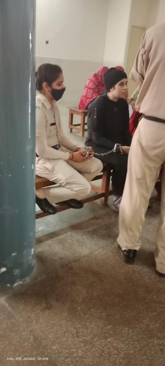 Legal support for a woman prisoner during a court hearing, March 2022