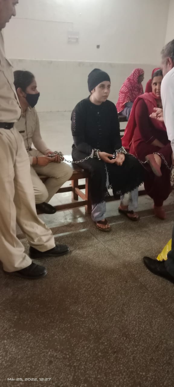 Legal support for a woman prisoner during a court hearing, March 2022
