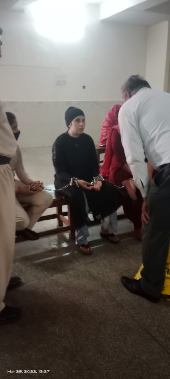 Legal support for a woman prisoner during a court hearing, March 2022