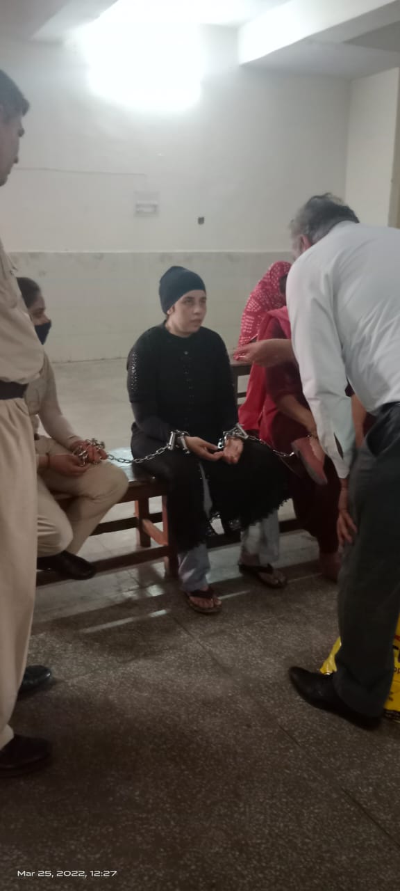 Legal support for a woman prisoner during a court hearing, March 2022