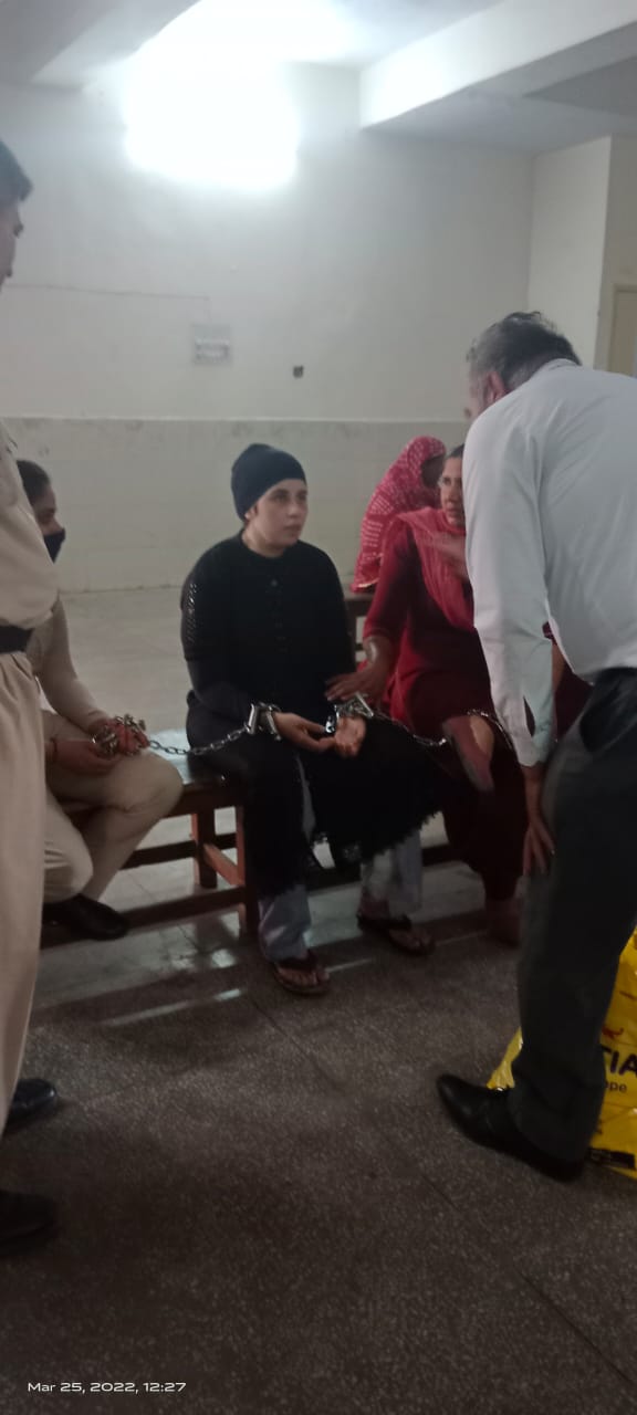 Legal support for a woman prisoner during a court hearing, March 2022