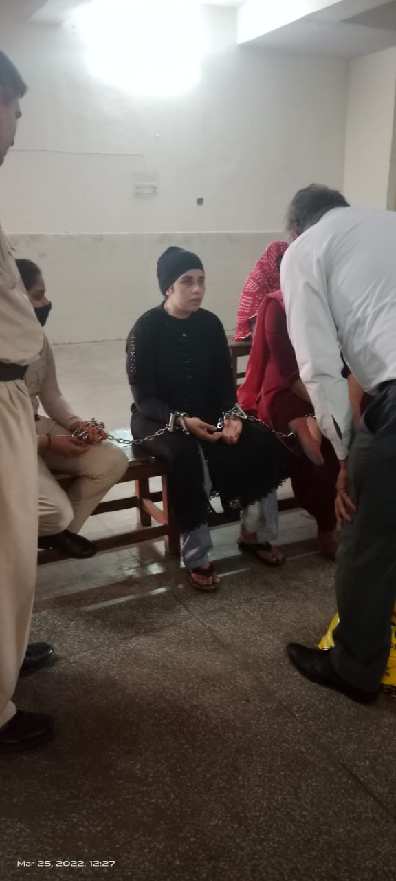 Legal support for a woman prisoner during a court hearing, March 2022